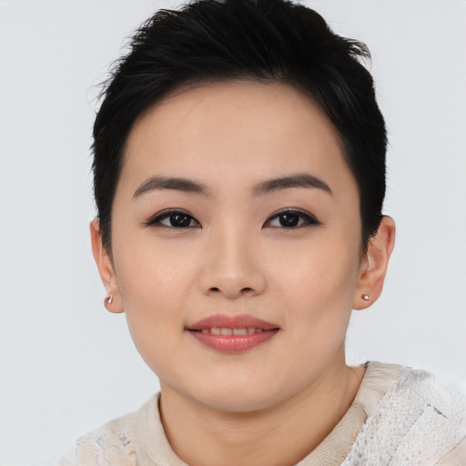 Joyful asian young-adult female with short  black hair and brown eyes