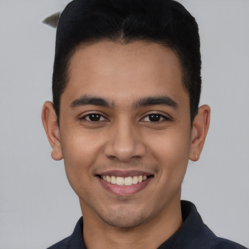 Joyful latino young-adult male with short  brown hair and brown eyes