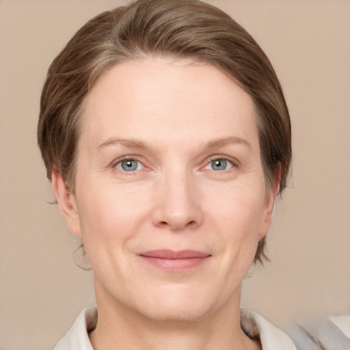 Joyful white adult female with medium  brown hair and grey eyes