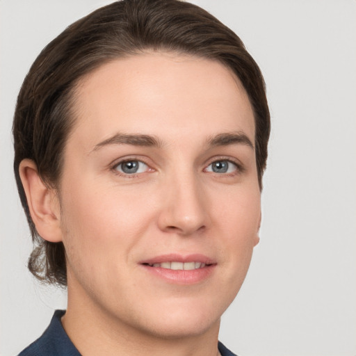 Joyful white young-adult female with short  brown hair and grey eyes