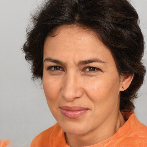 Joyful white adult female with medium  brown hair and brown eyes