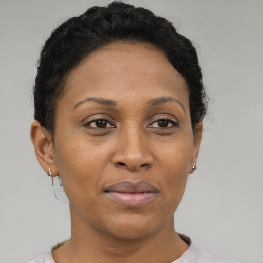 Joyful black adult female with short  brown hair and brown eyes