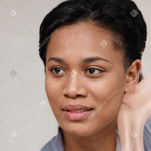 Joyful black young-adult female with short  brown hair and brown eyes