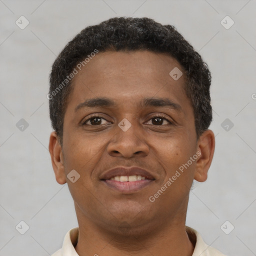 Joyful black young-adult male with short  brown hair and brown eyes