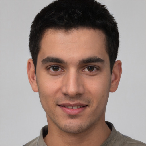Joyful white young-adult male with short  black hair and brown eyes
