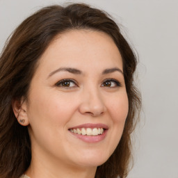 Joyful white young-adult female with medium  brown hair and brown eyes