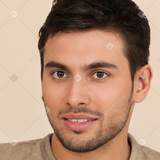 Joyful white young-adult male with short  brown hair and brown eyes