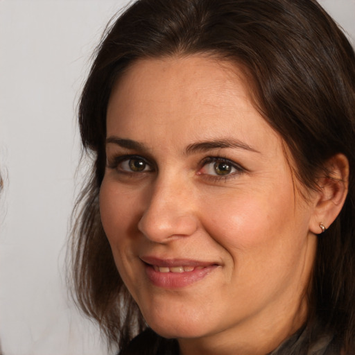 Joyful white adult female with medium  brown hair and brown eyes