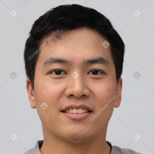 Joyful asian young-adult male with short  black hair and brown eyes