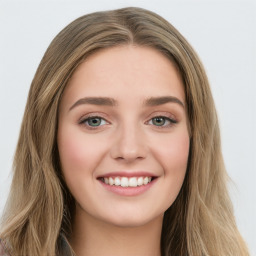 Joyful white young-adult female with long  brown hair and green eyes