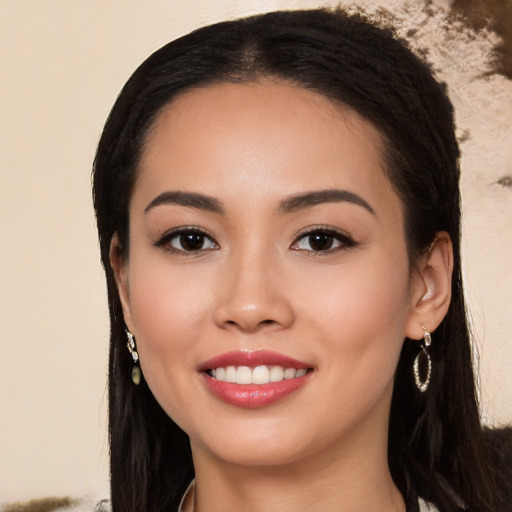 Joyful white young-adult female with long  black hair and brown eyes