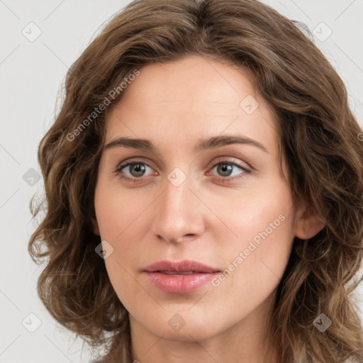 Joyful white young-adult female with long  brown hair and green eyes