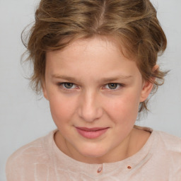 Joyful white child female with medium  brown hair and brown eyes