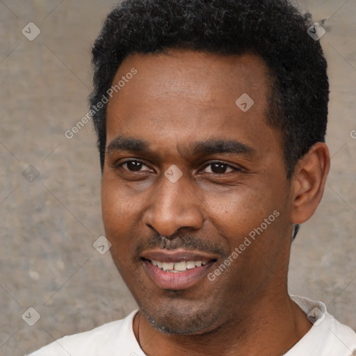 Joyful black young-adult male with short  black hair and brown eyes