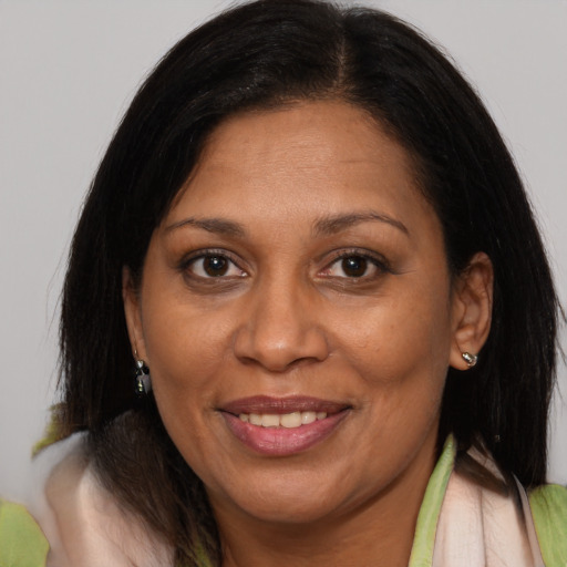 Joyful asian adult female with medium  brown hair and brown eyes