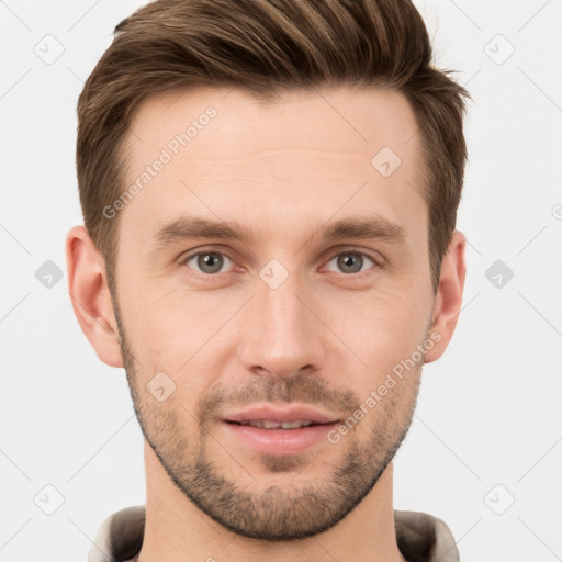 Joyful white young-adult male with short  brown hair and grey eyes