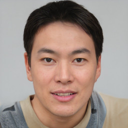 Joyful asian young-adult male with short  brown hair and brown eyes