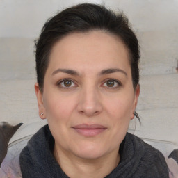 Joyful white adult female with medium  brown hair and brown eyes