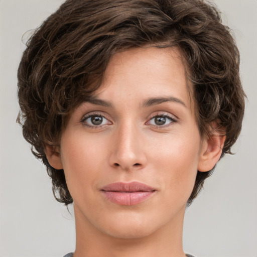 Joyful white young-adult female with medium  brown hair and green eyes