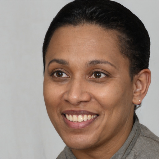 Joyful latino adult female with short  brown hair and brown eyes