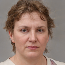 Joyful white adult female with medium  brown hair and grey eyes