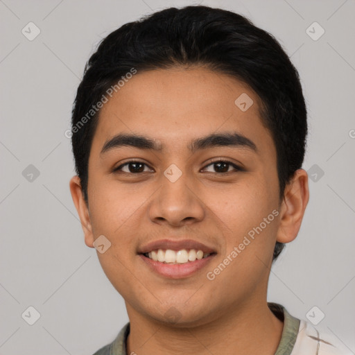 Joyful latino young-adult male with short  black hair and brown eyes