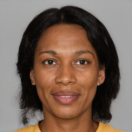 Joyful black adult female with medium  black hair and brown eyes