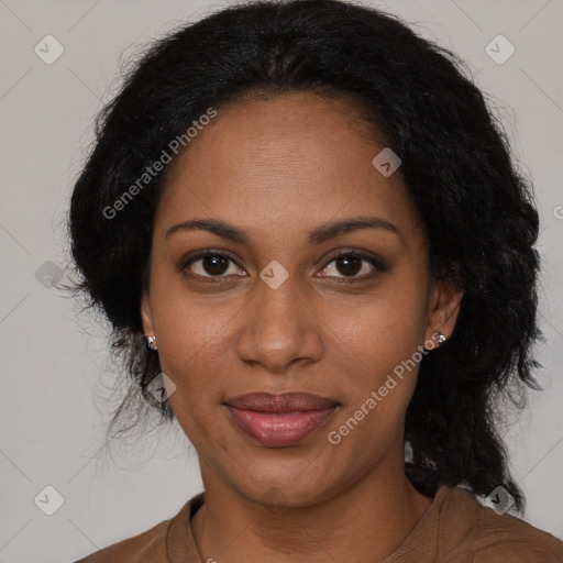 Joyful black adult female with long  brown hair and brown eyes