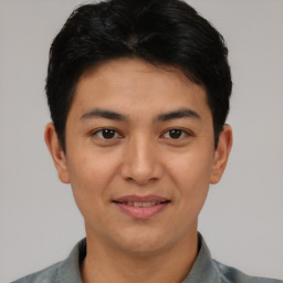 Joyful asian young-adult male with short  black hair and brown eyes