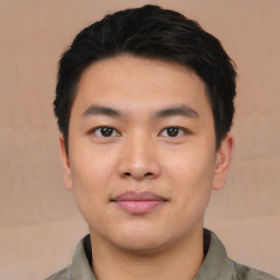 Joyful asian young-adult male with short  black hair and brown eyes