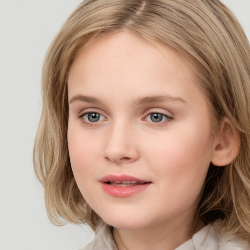 Joyful white child female with medium  brown hair and brown eyes