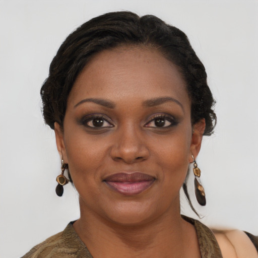 Joyful black young-adult female with long  brown hair and brown eyes