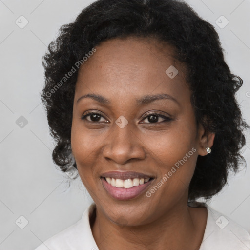 Joyful black adult female with short  brown hair and brown eyes