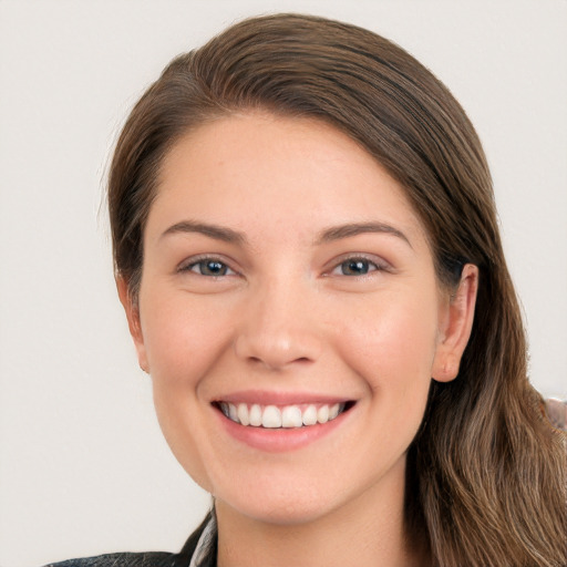 Joyful white young-adult female with long  brown hair and grey eyes