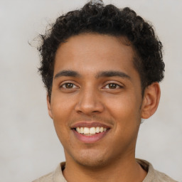 Joyful latino young-adult male with short  brown hair and brown eyes