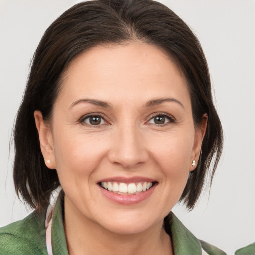 Joyful white adult female with medium  brown hair and brown eyes