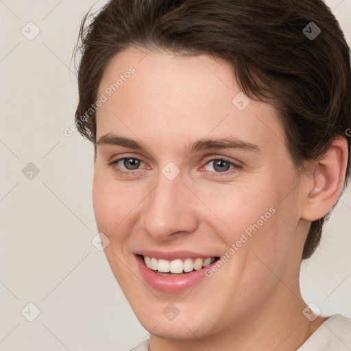 Joyful white young-adult female with short  brown hair and brown eyes