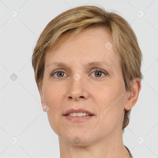 Joyful white adult female with short  brown hair and grey eyes