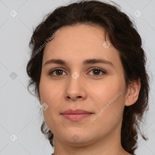 Joyful white young-adult female with medium  brown hair and green eyes