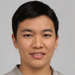 Joyful asian young-adult male with short  black hair and brown eyes