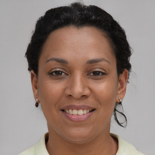 Joyful latino adult female with short  brown hair and brown eyes