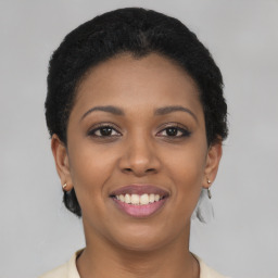 Joyful latino young-adult female with short  black hair and brown eyes