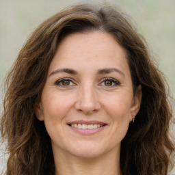 Joyful white adult female with long  brown hair and brown eyes
