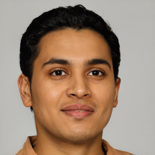 Joyful latino young-adult male with short  brown hair and brown eyes