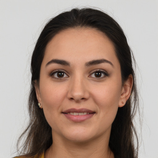 Joyful white young-adult female with long  brown hair and brown eyes