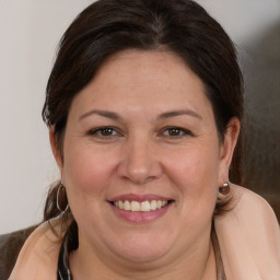 Joyful white adult female with medium  brown hair and brown eyes