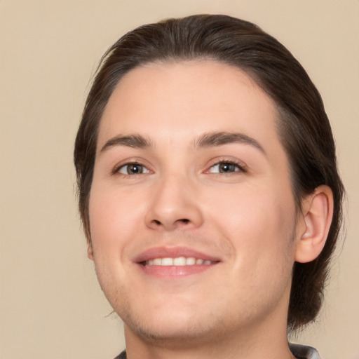 Joyful white young-adult male with medium  brown hair and brown eyes