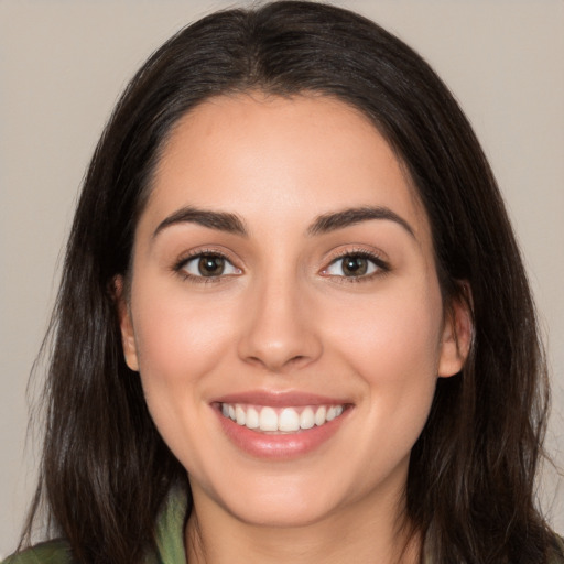 Joyful white young-adult female with long  brown hair and brown eyes