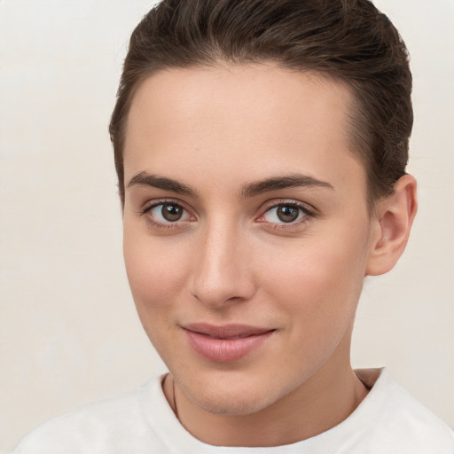 Joyful white young-adult female with short  brown hair and brown eyes