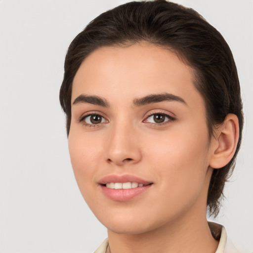 Joyful white young-adult female with long  brown hair and brown eyes